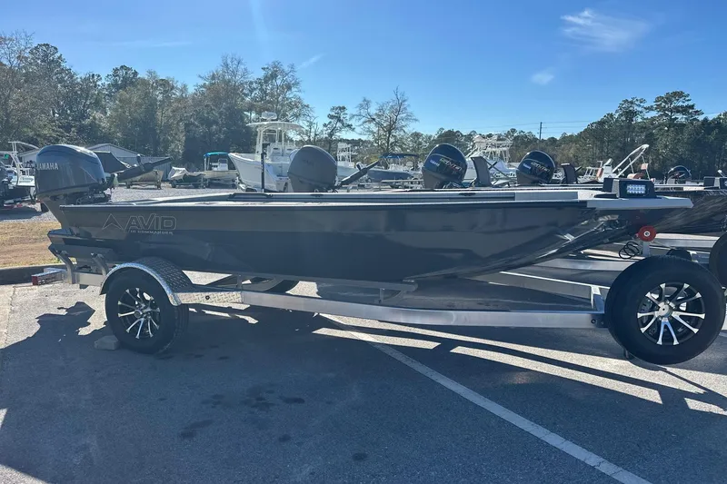 The Image of Avid 16 Commander 2026 boat on trailer, parked outdoors under clear sky. - 0