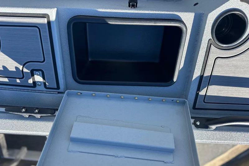 Slide: The Image of Dashboard storage compartment of 2026 Avid 16 Commander boat, open and empty. - 10