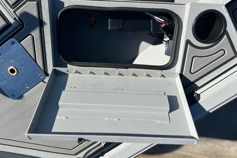 Slide: The Image of Avid 16 Commander 2026 boat dashboard with open compartment and wiring. - 11