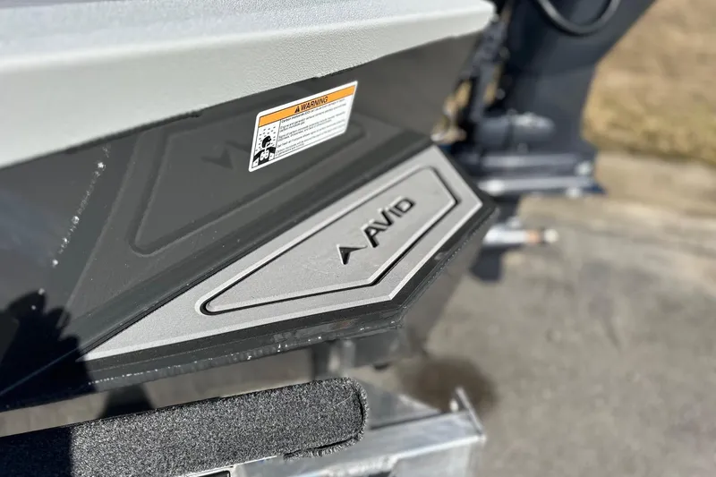Slide: The Image of Close-up of 2026 Avid 16 Commander boat detail with logo and warning label. - 14