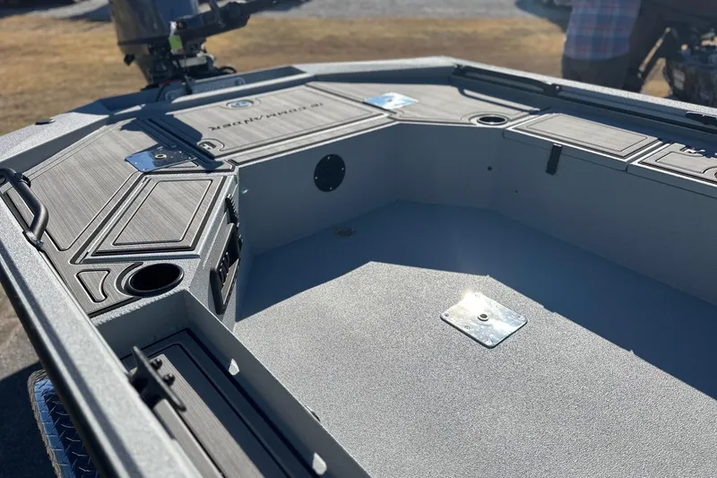 Slide: The Image of 2026 Avid 16 Commander boat interior with storage compartments and motor. - 4