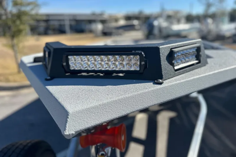 Slide: The Image of 2026 Avid 16 Commander boat with LED lights on textured surface. - 5