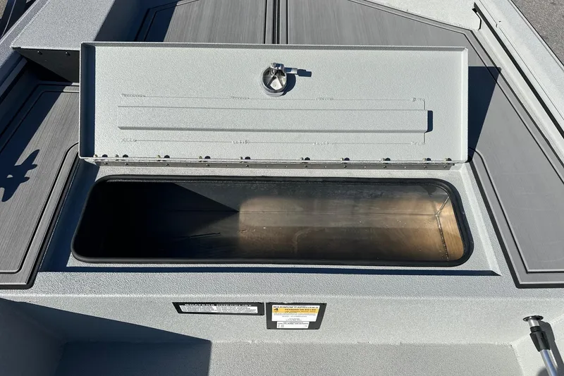 Slide: The Image of Open storage compartment on 2026 Avid 16 Commander boat deck. - 8