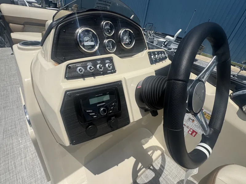 Slide: The Image of The image shows a boat's helm with multiple gauges and a steering wheel. - 12