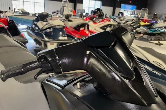 Slide: The Image of 2020 Yamaha WaveRunner FX Cruiser SVHO handlebars in a showroom with multiple jet skis. - 17