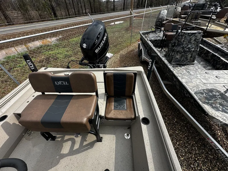 Slide: The Image of 2026 Excel 220 Bay Pro Elite boat with Suzuki engine, brown seats. - 7