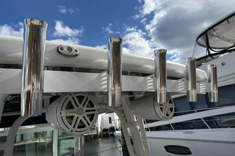 Slide: The Image of 2018 HCB 39 Speciale boat with rod holders and JL Audio speakers under a blue sky. - 11