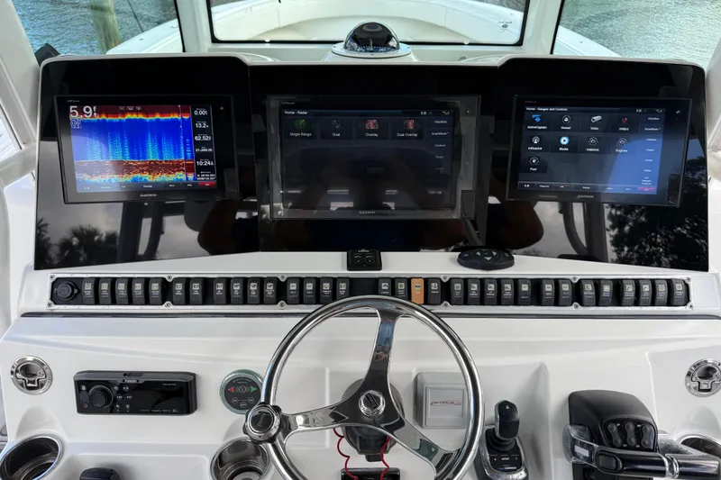Slide: The Image of 2018 HCB 39 Speciale boat dashboard with advanced navigation displays and controls. - 14