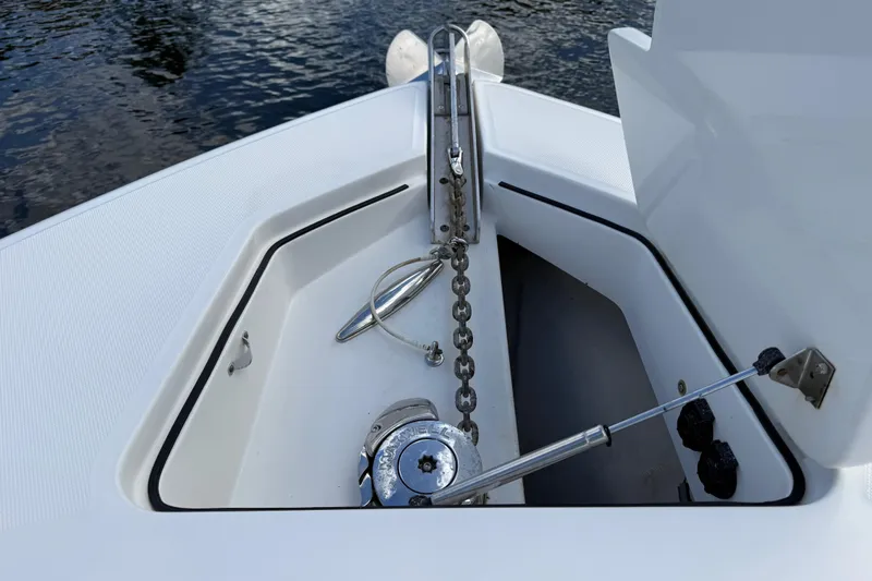 Slide: The Image of 2018 HCB 39 Speciale boat anchor compartment with chain and winch, near water surface. - 16