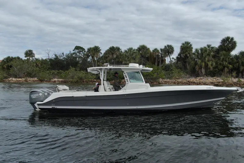 Slide: The Image of 2018 HCB 39 Speciale boat cruising near a lush, tropical shoreline. - 3