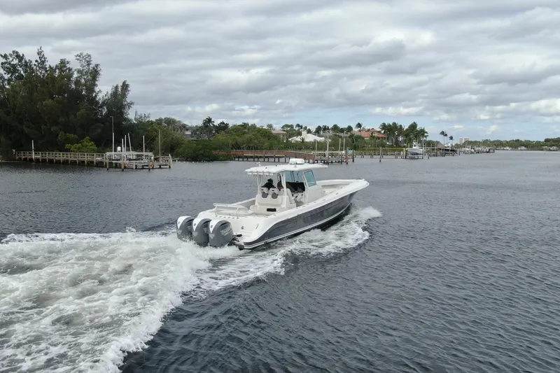 Slide: The Image of 2018 HCB 39 Speciale boat cruising on a scenic waterway under cloudy skies. - 34