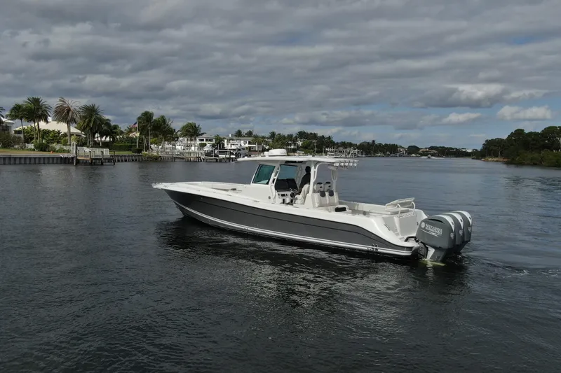 Slide: The Image of 2018 HCB 39 Speciale boat cruising on a scenic waterway under cloudy skies. - 35