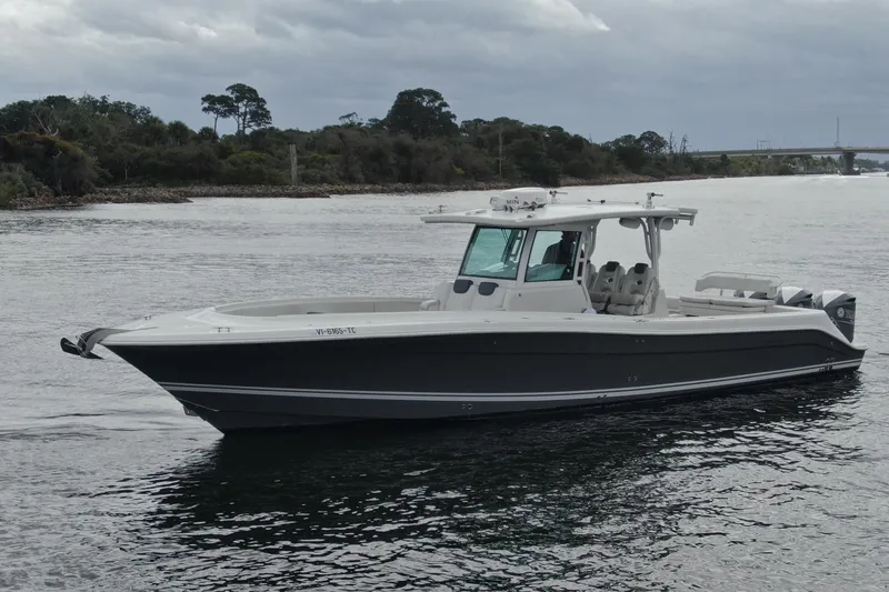 Slide: The Image of 2018 HCB 39 Speciale boat on calm water, overcast sky, near shoreline. - 38