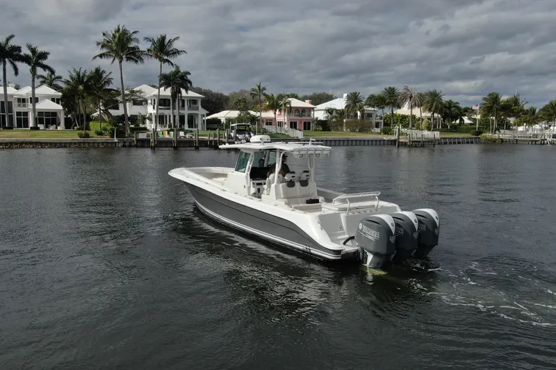 Slide: The Image of 2018 HCB 39 Speciale boat cruising near waterfront homes and palm trees. - 41