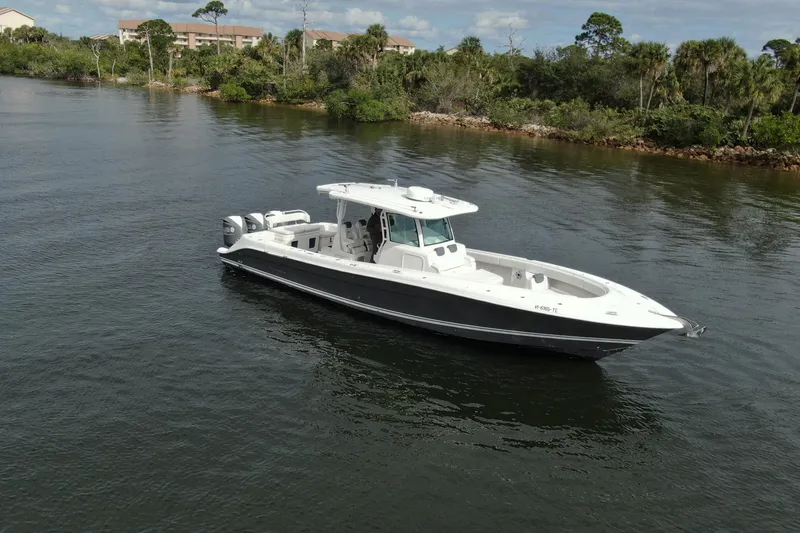 Slide: The Image of 2018 HCB 39 Speciale boat cruising on a calm river with lush greenery. - 42