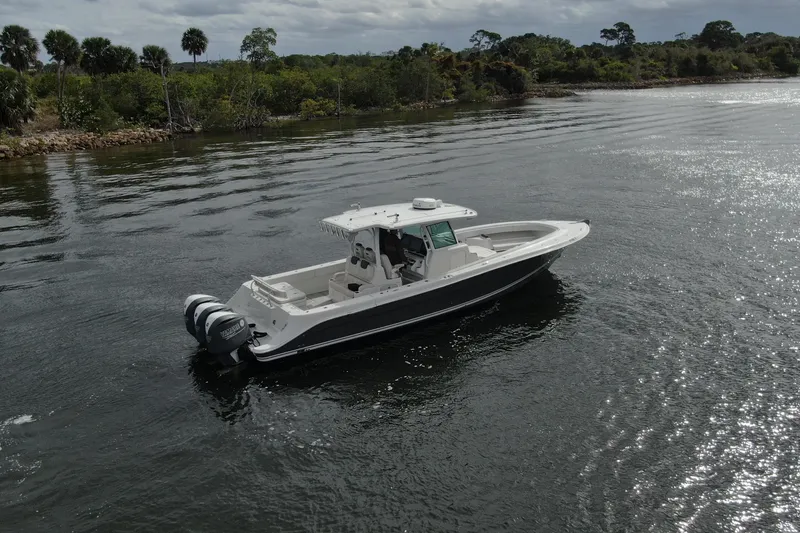 Slide: The Image of 2018 HCB 39 Speciale boat cruising on a calm river with lush greenery. - 44