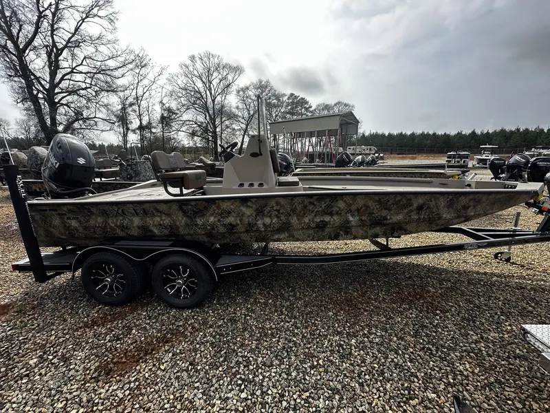 Slide: The Image of 2026 Excel 220 Bay Pro Elite boat on trailer, parked outdoors. - 1