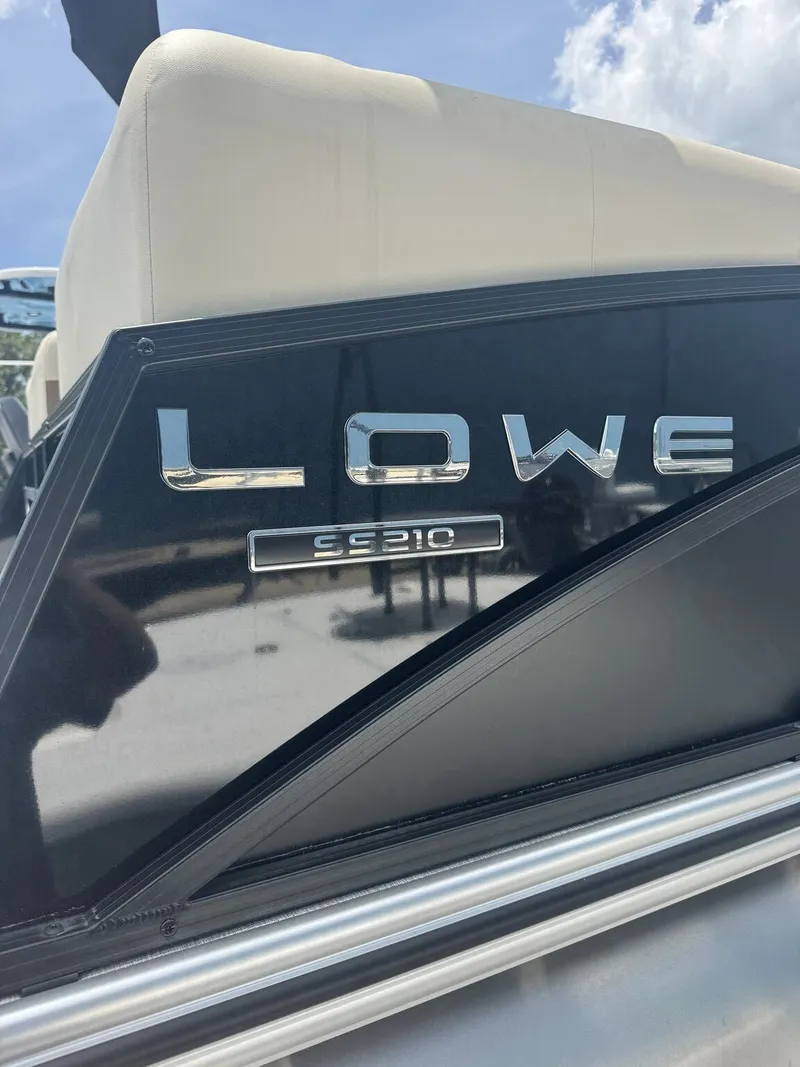 Slide: The Image of Close-up of the nameplate on a Lowe LS Walk Thru 210 boat. - 2