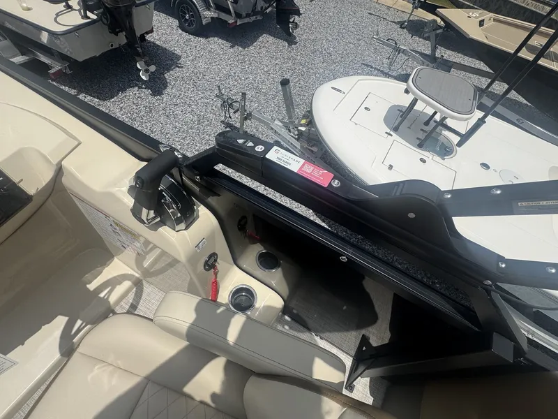 Slide: The Image of The image shows the cockpit of a 2026 Lowe LS Walk Thru 210 boat with beige seating. - 11