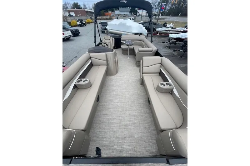 Slide: The Image of 2022 Bennington 20 SLX pontoon boat interior with beige seating and cup holders. - 5