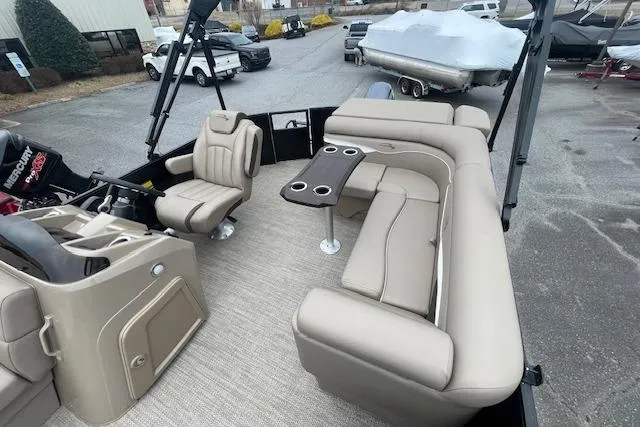 Slide: The Image of 2022 Bennington 20 SLX pontoon boat interior with beige seating and table. - 6