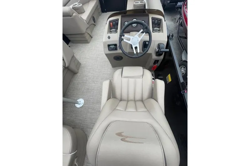 Slide: The Image of 2022 Bennington 20 SLX boat interior with beige captain's chair and steering console. - 7