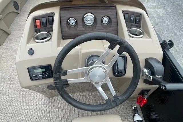 Slide: The Image of 2022 Bennington 20 SLX boat dashboard with steering wheel and control panel. - 8
