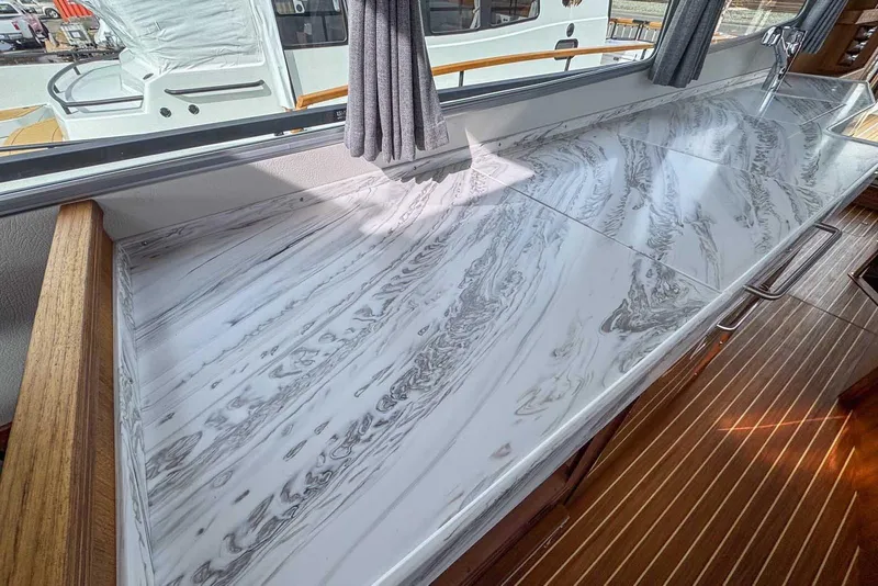 Slide: The Image of Luxurious marble countertop in 2025 Targa 46 yacht interior, featuring elegant wood accents. - 17