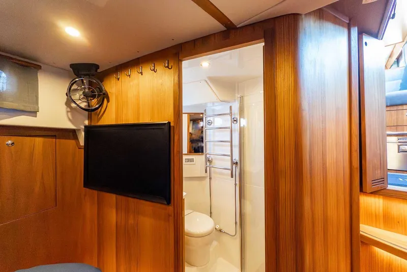 Slide: The Image of Luxurious interior of 2025 Targa 46 yacht featuring wood paneling and modern bathroom. - 27