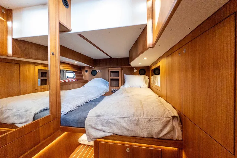 Slide: The Image of Luxurious 2025 Targa 46 yacht cabin with twin beds and elegant wood finish. - 30