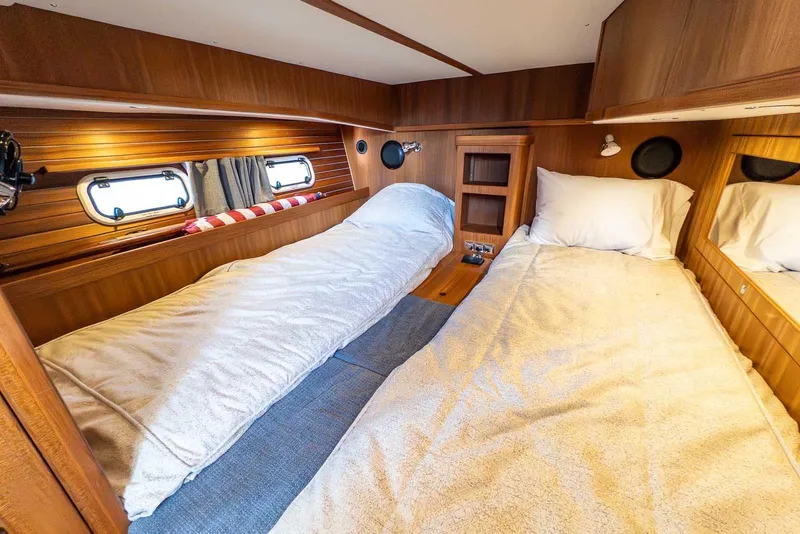 Slide: The Image of Cozy cabin interior of 2025 Targa 46 yacht with twin beds and wooden finish. - 31