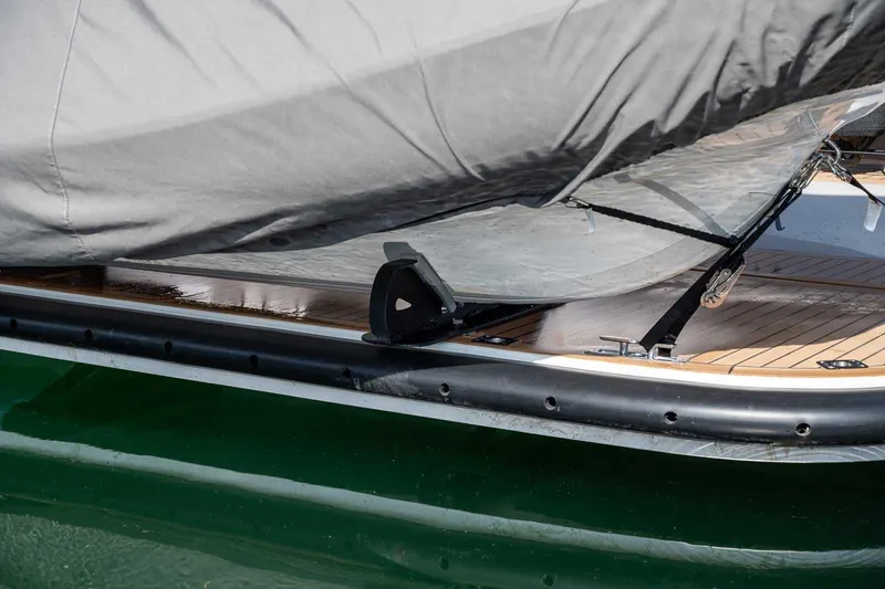 Slide: The Image of 2025 Targa 46 boat with protective cover on wooden deck, docked in water. - 6