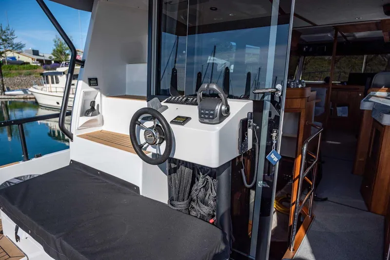 Slide: The Image of 2025 Targa 46 boat helm with modern controls and sleek interior design. - 7