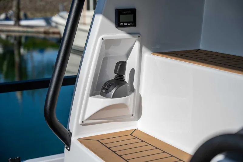 Slide: The Image of 2025 Targa 46 boat interior with joystick control and wooden steps. - 8