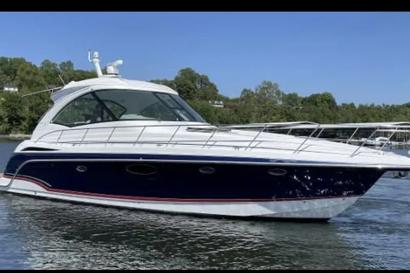The Image of 2008 Formula 45 Yacht cruising on a serene lake with lush green shoreline. - 0