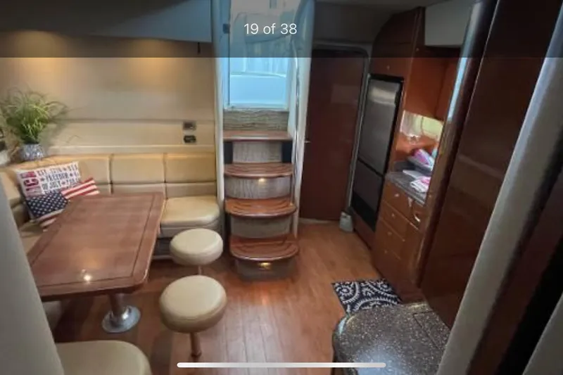 Slide: The Image of Interior of 2008 Formula 45 Yacht with dining area and kitchen, featuring wood finishes. - 12