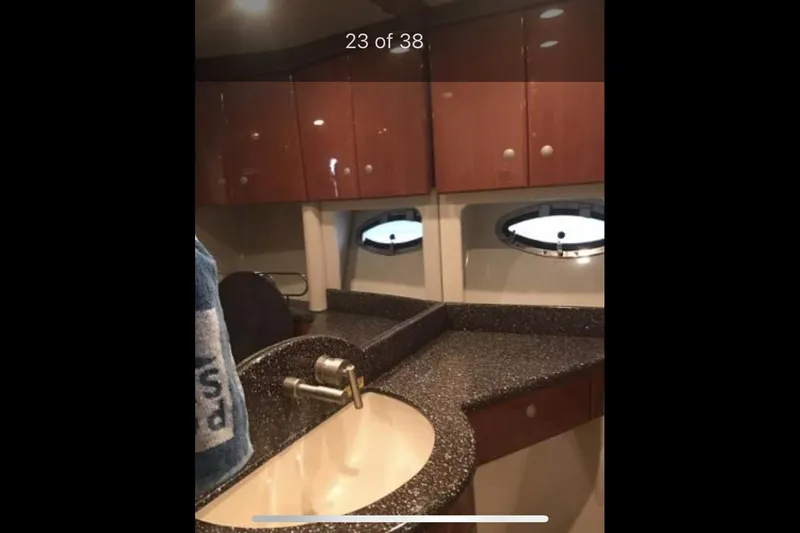 Slide: The Image of 2008 Formula 45 Yacht bathroom with sleek countertop, sink, and wooden cabinets. - 14