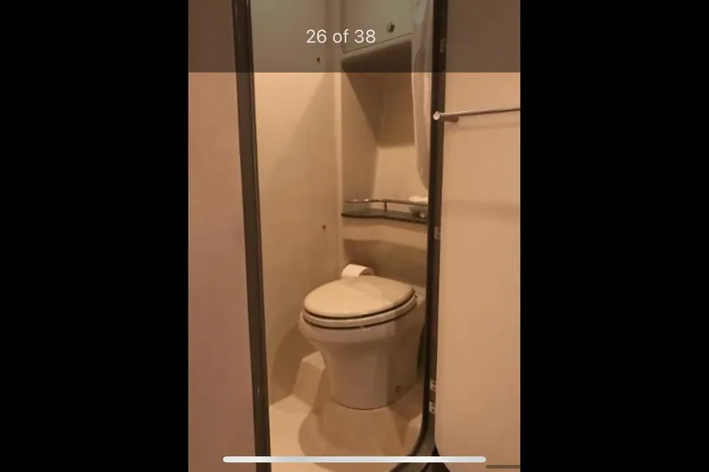Slide: The Image of Bathroom interior of a 2008 Formula 45 Yacht, featuring a compact toilet. - 16