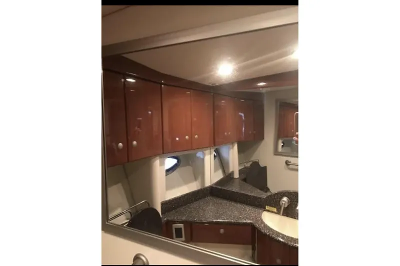 Slide: The Image of Interior of 2008 Formula 45 Yacht bathroom with wooden cabinets and granite countertop. - 17