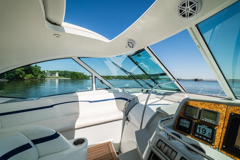 Slide: The Image of Interior view of a 2008 Formula 45 Yacht cockpit with scenic waterway backdrop. - 55