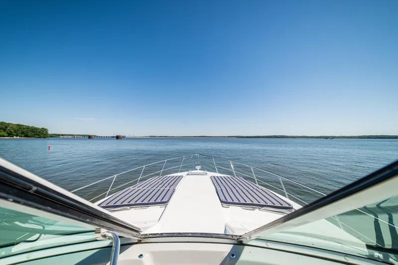 Slide: The Image of 2008 Formula 45 Yacht cruising on a serene lake under a clear blue sky. - 56