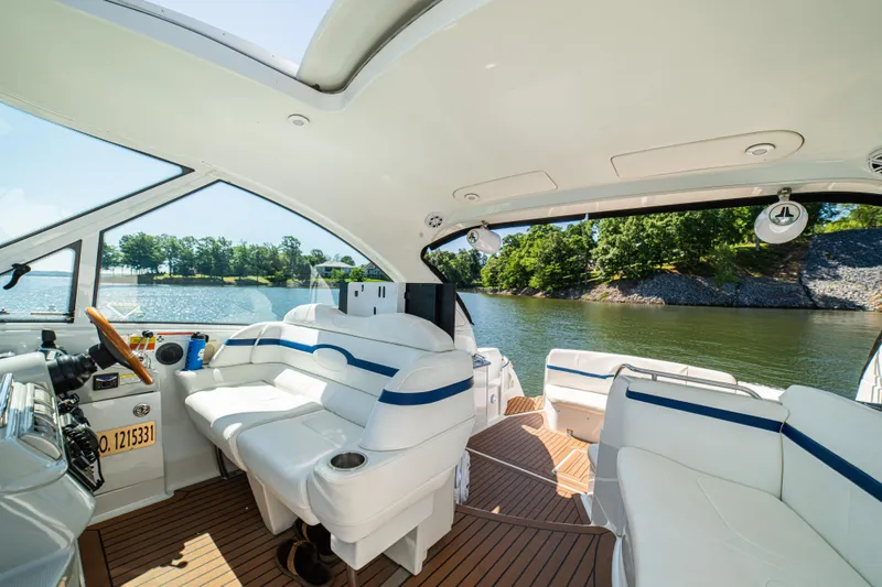 Slide: The Image of Interior view of a 2008 Formula 45 Yacht with luxurious seating and scenic water backdrop. - 58
