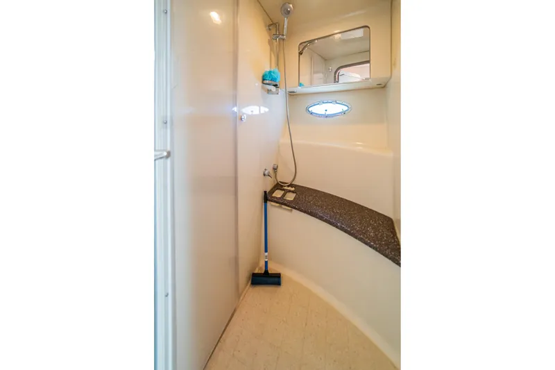 Slide: The Image of Interior shower area of a 2008 Formula 45 Yacht, featuring a sleek design and porthole window. - 84