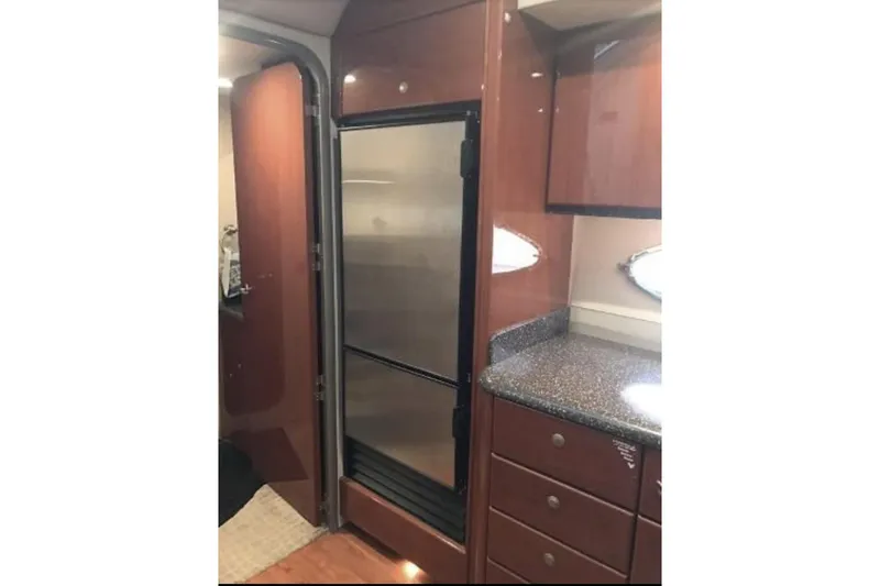 Slide: The Image of Interior of 2008 Formula 45 Yacht with wood cabinetry and stainless steel fridge. - 9