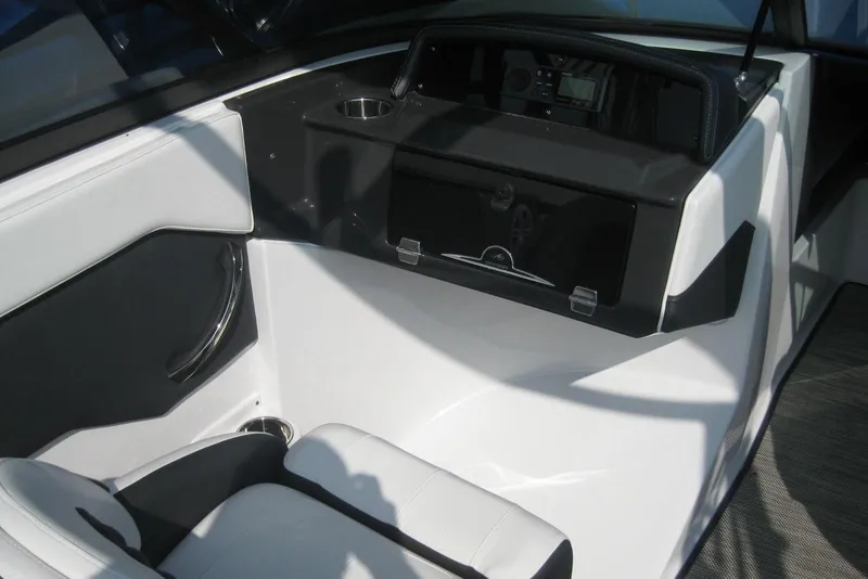 Slide: The Image of 2024 Monterey M-22 boat storage compartment with battery and cushioned seating. - 11