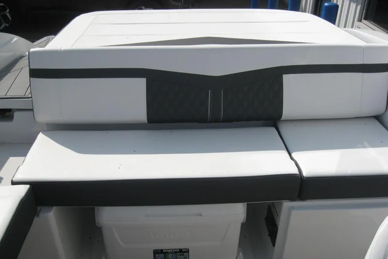 Slide: The Image of 2024 Monterey M-22 boat interior with white seating and gray flooring. - 6