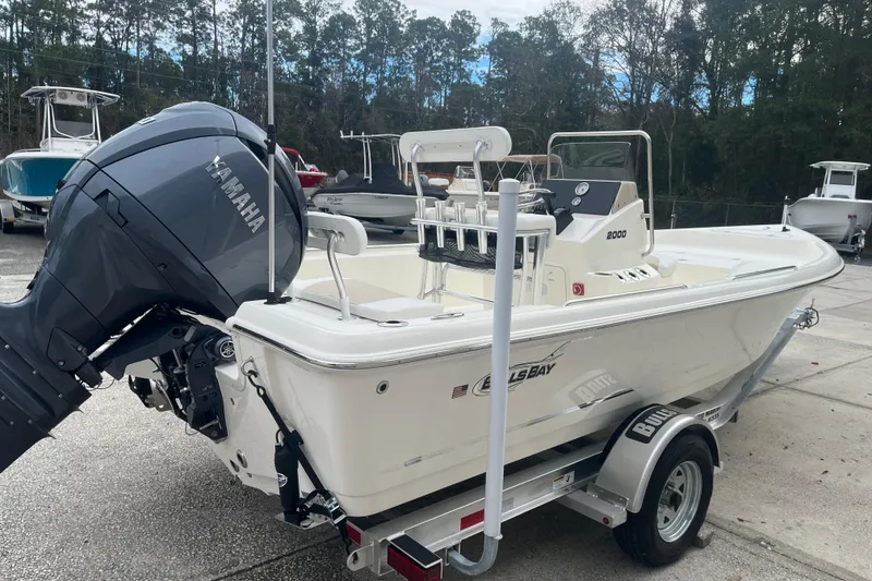Slide: The Image of 2026 Bulls Bay 2000 boat with Yamaha engine on trailer, parked outdoors. - 11