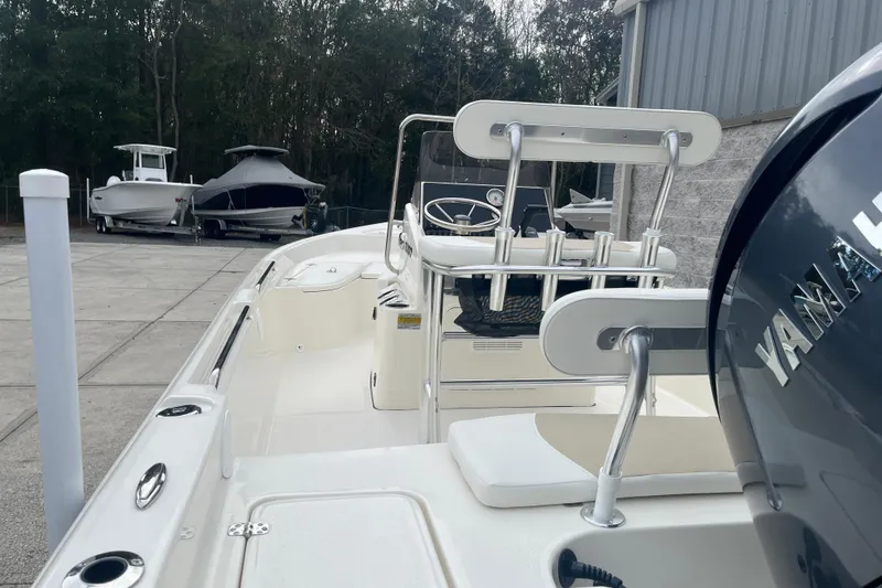 Slide: The Image of 2026 Bulls Bay 2000 boat with Yamaha engine, docked outdoors near other boats. - 13