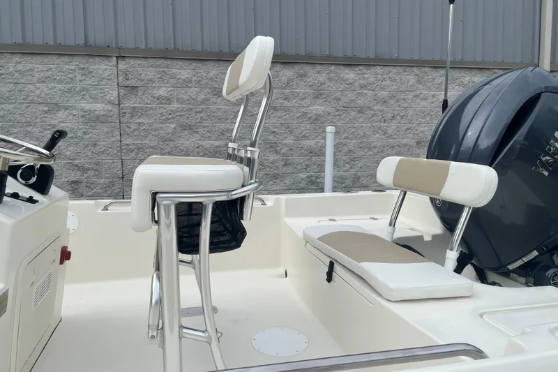 Slide: The Image of 2026 Bulls Bay 2000 boat interior with seating and steering console, featuring a powerful outboard motor. - 14