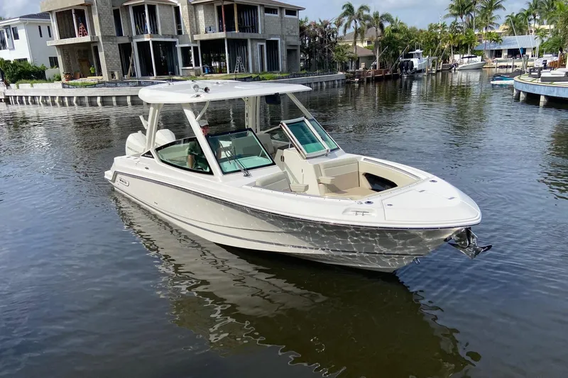 The Image of 2021 Boston Whaler 280 Vantage boat docked in a serene waterfront setting. - 0